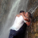 couple kissing under waterfall