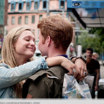 couple on street kissing blonde girl